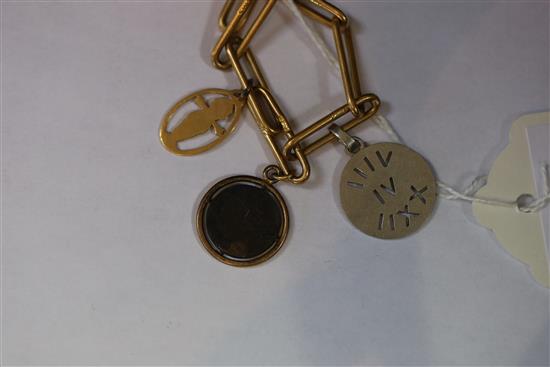 An 18ct bracelet, hung with five assorted charms, gross 33 grams.